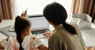Parent aidant son enfant à faire ses devoirs après les heures de classe.