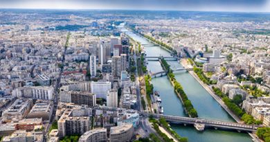 Vue aérienne de Paris avec la Seine traversant la ville et plusieurs ponts.